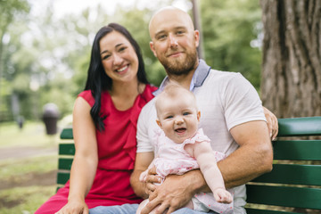 Father Mother and daughter baby in summer meadow park