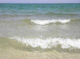 closeup waves with foam on the sea