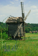 Old wooden windmill in a meadow