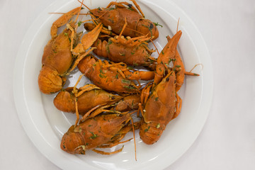 Boiled crayfish on a white plate.