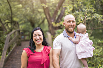 Father Mother and daughter baby in summer meadow park