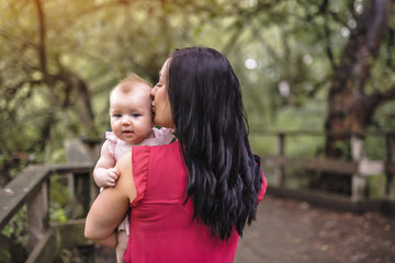 Mother and daughter baby in summer meadow park