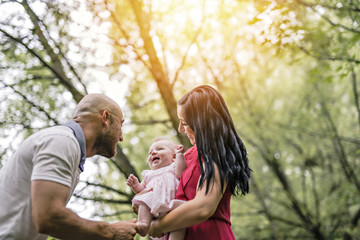Fototapeta premium Father Mother and daughter baby in summer meadow park