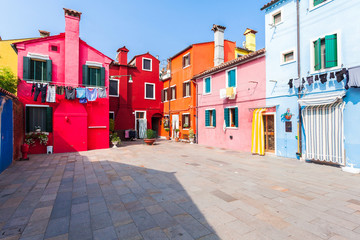 Picturesque patio with colored houses on the island of Burano. Travel around Italy