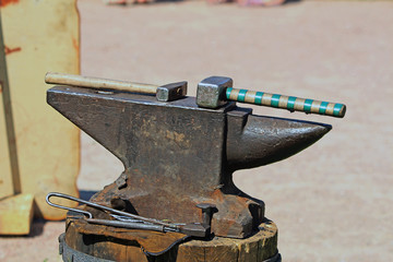 Hammer and a hammer on an ancient anvil