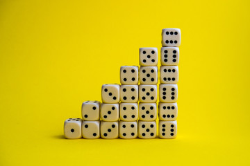 dice on a yellow background, lined stairs