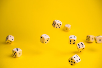 dice in the fall on a yellow background