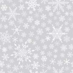 Christmas seamless pattern of snowflakes, white on gray background.