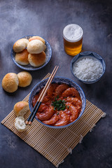 Bowl of asian spicy asian shrimps with beer