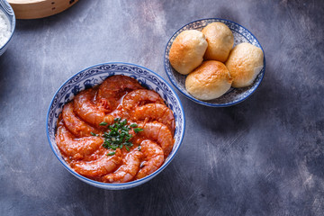 Bowl of shrimps in spicy tomato sauce, singaporean cuisine, copyspace