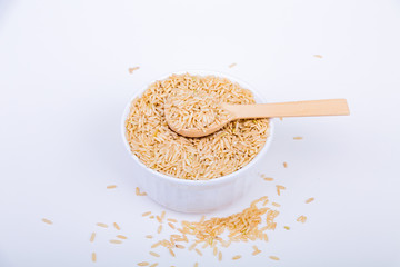 Brown Rice in a White Bowl with Wood Spoon
