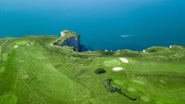 Drone view of a cliff side golf course next to the ocean in Etretat Normandie France