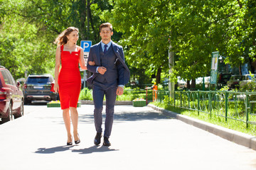 Young couple or european woman and man walking on city street