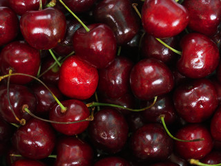 Fresh sweet cherry background, prunus avium. Close-up wild cherry fruit texture, surface