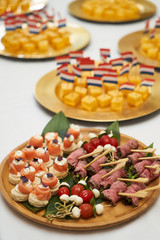 Dutch canapes on a white background. Pieces of traditional Dutch cheese with flag as a snack, top view