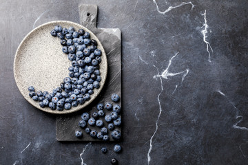 Fresh Blueberries on the Black Marble Background and the Dark Slate Board. Concept  Healthy Food. Diet Nutrition .Top View. Flat Lay.selective focus.