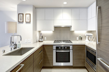 Modern style kitchen with wood paneled refrigerator.