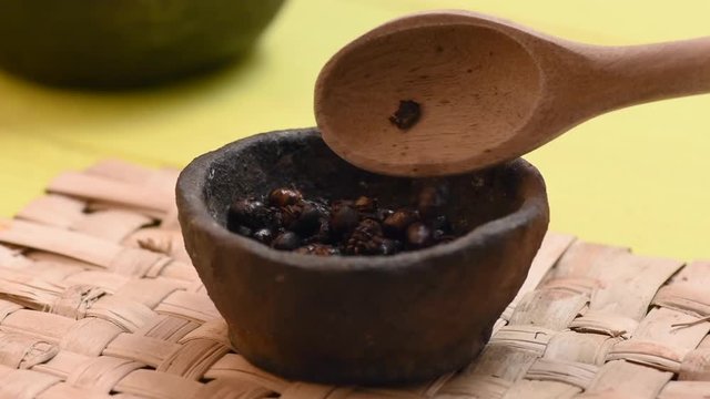 Spoonful roasted ants added to cup