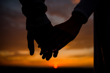 Together.Couple.Hold hands.Photo at sunset.Hand.Silhouette photo.Lover
