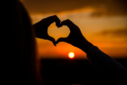 Love.A symbol of love.Heart.Photo at sunset.Hand.Silhouette photo.Lover