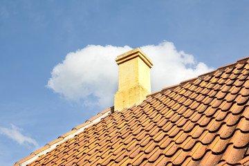 Old town of Odense, Denmark. Tile roof with chimney.