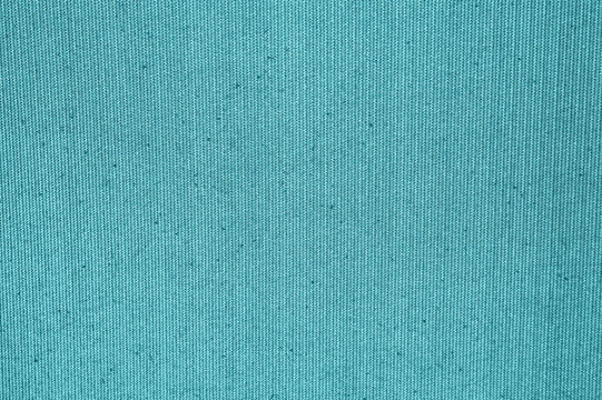 Cloth backdrop. Structure of the pastel turquoise fabric with natural texture. Light blue background from a textile material with wicker pattern. Texture of dark blue felt. High resolution photo