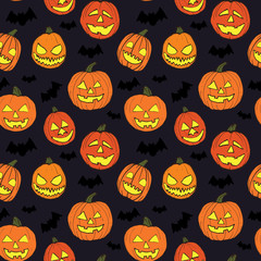 Halloween seamless vector pattern with hand drawn orange pumpkins carved faces and black bats on dark background.