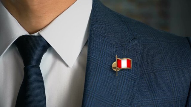 Businessman Walking Towards Camera With Country Flag Pin - Peru