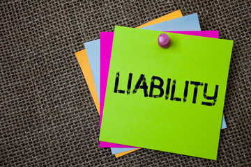 Handwriting text writing Liability. Concept meaning State of being legally responsible for something Responsibility Sticky cards board pinned muliple colours remember idea jute background.