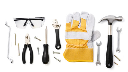 Construction safety equipment and tools on white background.