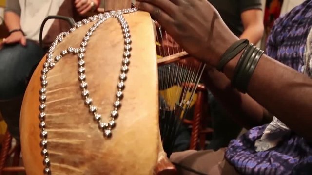 Group of musicians dressed colorfully and playing african music
