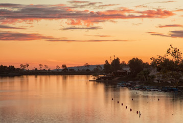 Photograph of an orange sunset over a lake