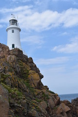 Fototapeta na wymiar Escape the heatwave. Discover the lighthouse in Jersey. England, July, 2018