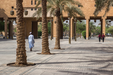 RIYADH, SAUDI ARABIA - OCTOBER 15, 2015. A saudi arabian muslim man walks on Deera Square or Chop-Chop Square in the center of Riyadh near mosque