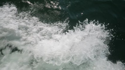 A slow motion top down view of the wake caused by the bow of a ship. Shot at 60fps.  	