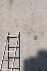 Ladder placed on a concrete wall