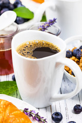 Coffee. Continental Breakfast with croissants, cereals and fruits. Selective focus.