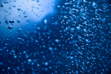 Blue clear water with bubbles, abstract liquid background