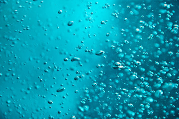 Blue clear water with bubbles, abstract liquid background