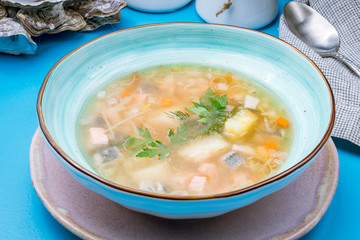 Fish soup on blue plate