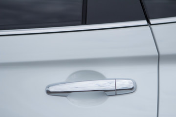 Closeup of white car door handle front view.