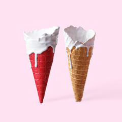 Cones for ice cream in the stains of white paint on a light pink background