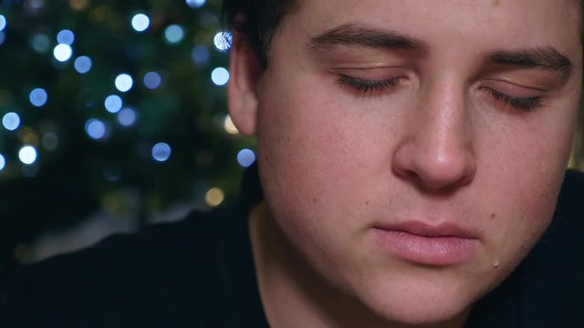 Sadness at Christmas Depressed Young man alone crying