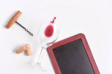Chalkboard with wine glass, corkscrew, corks, and wine spill