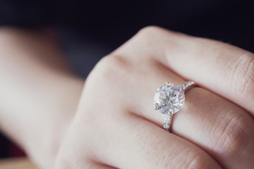 engagement diamond ring on woman finger closeup - obrazy, fototapety, plakaty