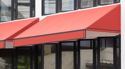 orange awning over glass windows and black aluminium frame, canvas shading