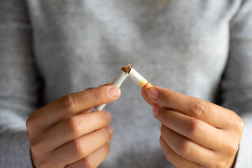 World No Tobacco Day, May 31. STOP Smoking. Close up woman hand breaking, crushing or destroying...