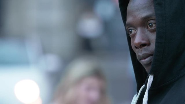pensive lonely black migrant in the street