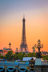 Sunset view of  Eiffel Tower and Alexander III Bridge in Paris, France.