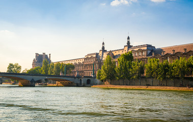  View on Pont du Carrousel and Louvre Museum from Seine river in Paris, France